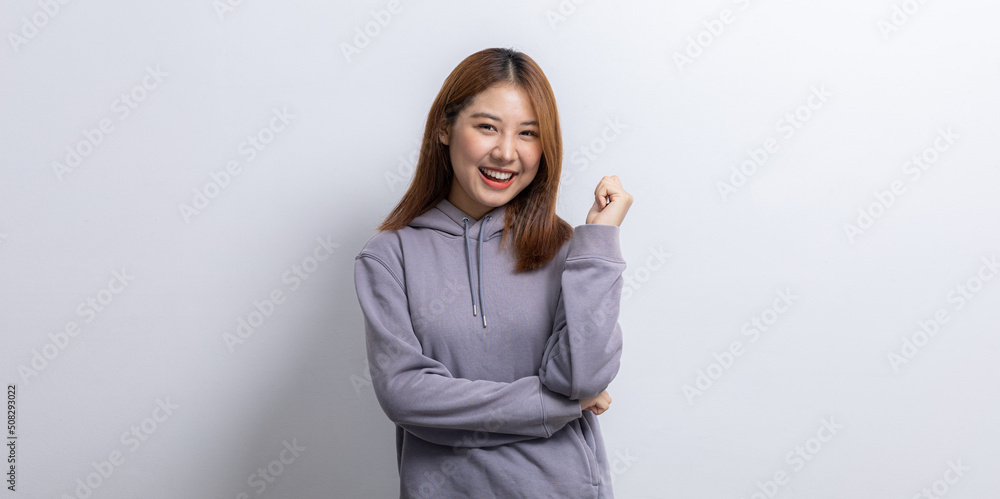 Portrait of beautiful Asian woman doing cheerful pose on isolated background, portrait concept used for advertisement and signage, isolated over white background, copy space.