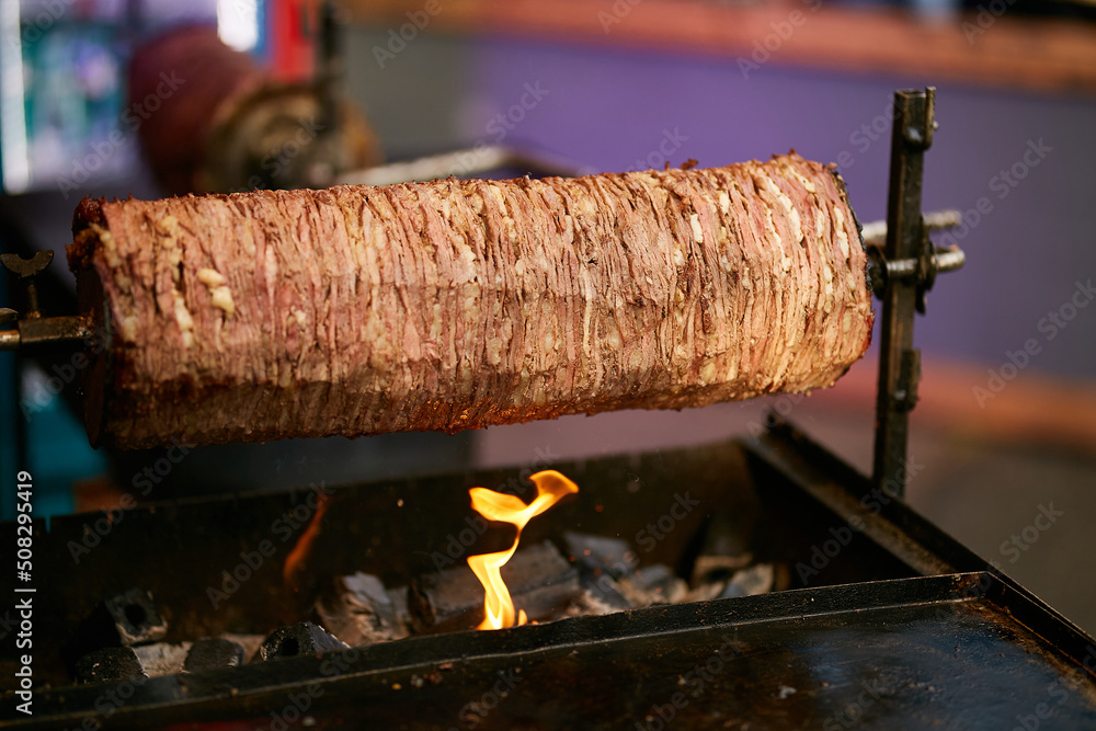 Doner Kebab On Rotating Spit. Traditional Turkish food Doner Kebab