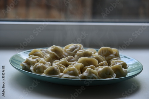 Cooked dumplings on a plate in the kitchen photo