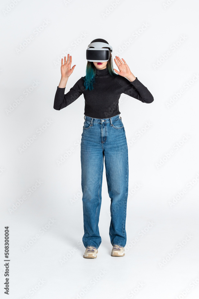 Teen girl using vr headset is in virtual reality cyberspace futuristic white background. The concept of the metaverse, virtual reality, virtual social universe. Future digital technologies. Teen girl using vr headset is in virtual reality cyberspace futuristic white background. The concept of the metaverse, virtual reality, virtual social universe. Future digital technologies.