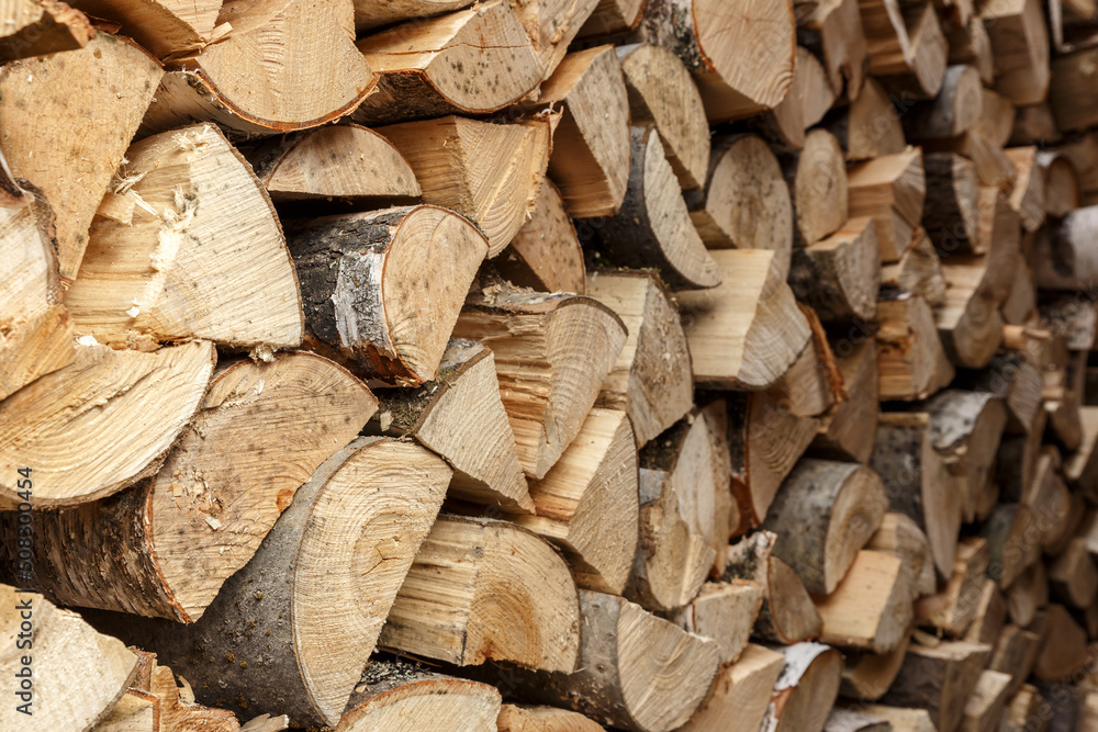 firewood stacked in the woodpile, textured firewood background of chopped wood firewood stacked in the woodpile, textured firewood background of chopped wood