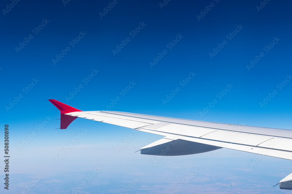 Fototapeta premium airplane flight view from inside the plane in a blue sky