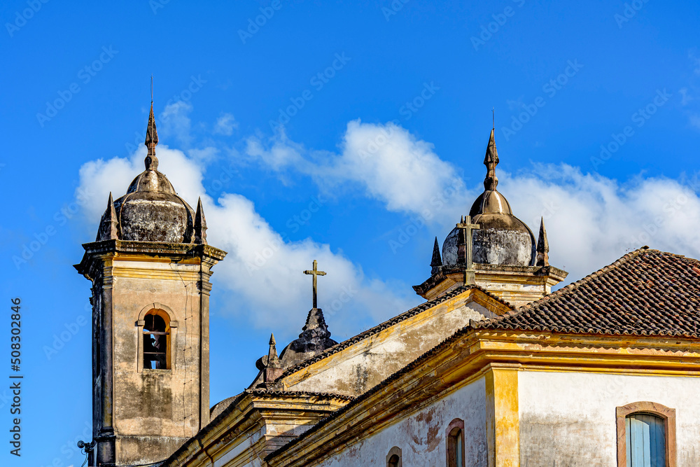 Beautiful historic church in baroque style with its towers jutting out against the blue sky in Ouro Preto, Minas Gerais