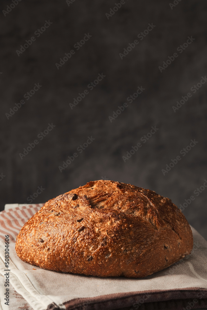 Healthy bakery bread, loaf of artisan grain bread on the table, vertical frame