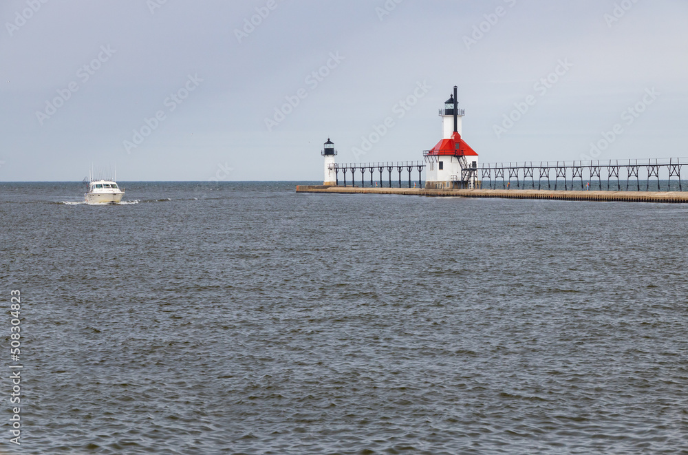 Fishing boat in the channel at St. Joseph North Pier Inner Lighthouse and St. Joseph North Pierhead Outer Lighthouse, Michigan