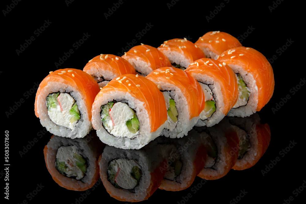 Sushi roll (Philadelphia) with salmon, prawn, avocado, cream cheese on black background. Sushi menu. Japanese food. Sushi roll (Philadelphia) with salmon, prawn, avocado, cream cheese on black background. Sushi menu. Japanese food.