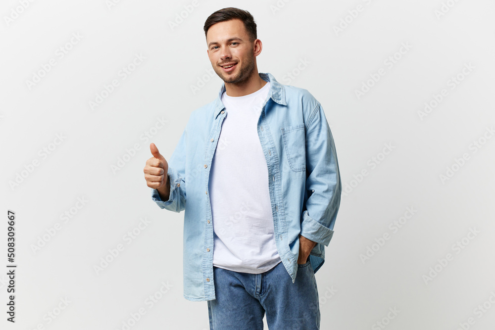 Cheerful happy tanned handsome man in casual basic t-shirt show thumb up gesture Like posing isolated on over white studio background. Copy space Banner Mockup. Lifestyle People emotions concept Cheerful happy tanned handsome man in casual basic t-shirt show thumb up gesture Like posing isolated on over white studio background. Copy space Banner Mockup. Lifestyle People emotions concept