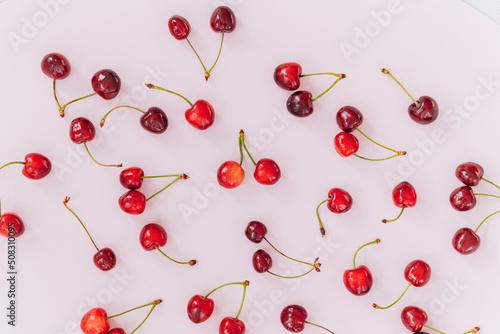 Cherry pattern. Flat lay of cherries on a pink background.Top view