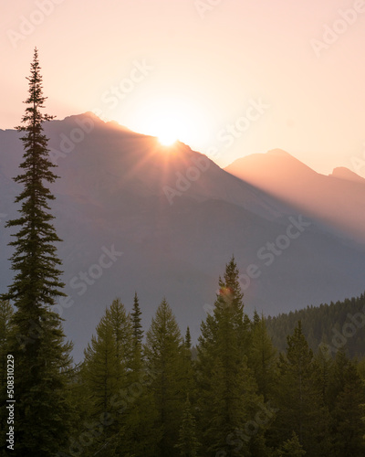Sun peaking over the mountains, Montana