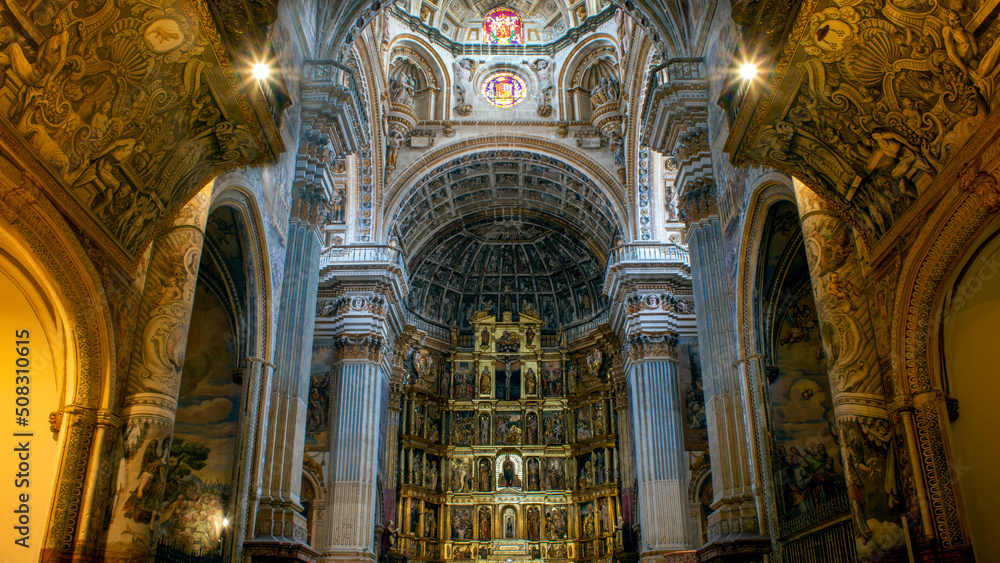 Interior of the monastery of San Jerónimo in Granada, Andalusia, Spain. Central nave with the altar in the background and a set of artificial and natural lighting
