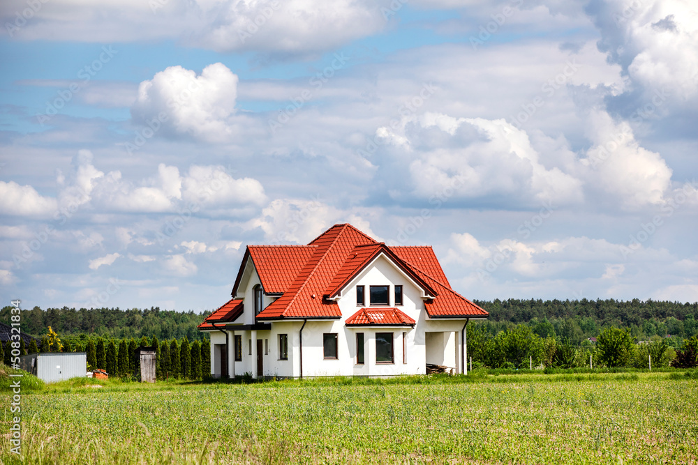 beautiful rural landscape with a lonely house with red tiles on a sunny summer day.. rural landscape,