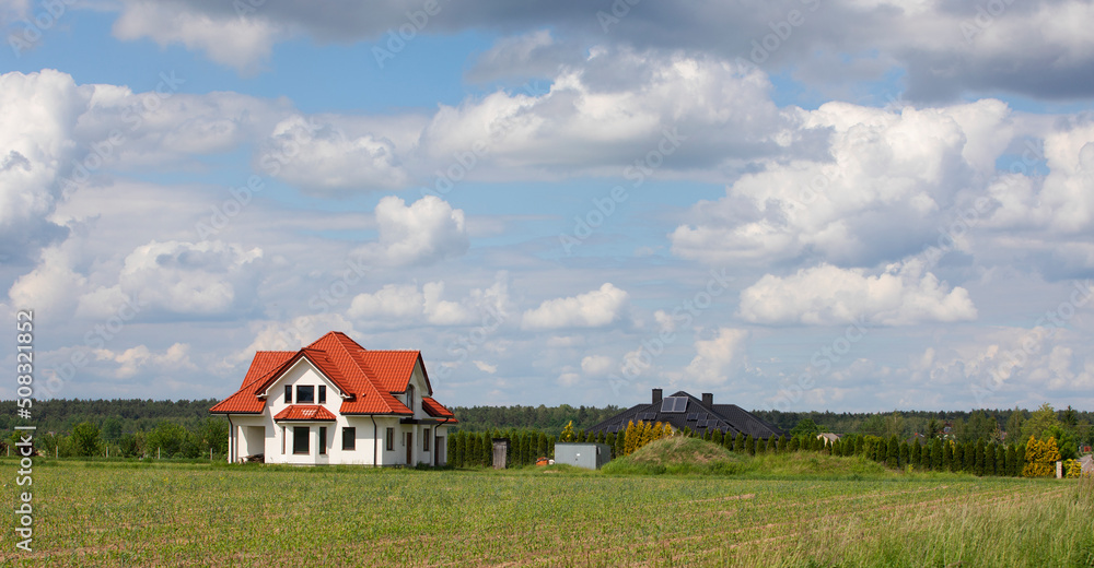 beautiful rural landscape with a lonely house on a sunny summer day..