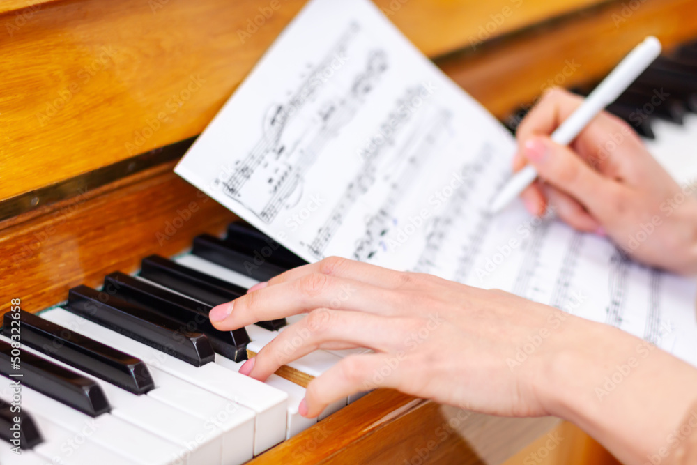 Woman's hands playing piano at home. The woman is professional pianist  arranging music using piano keyboards. Musician practicing keyboard  composing music. Artist create instrumental acoustic melody. Stock Photo |  Adobe Stock