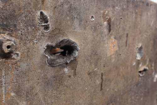 Bullet holes in Rusty russian tank burned by the Ukrainian military during Russian invasion of Ukraine in 2022. Downtown of Kyiv, capital of Ukraine. photo