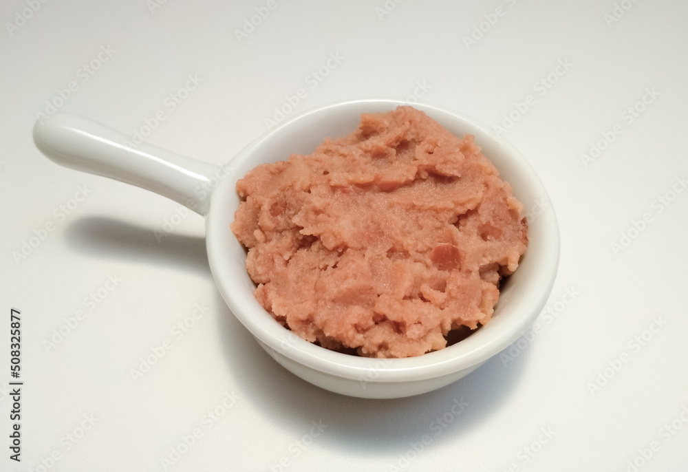 Refried beans (Phaseolus vulgaris) in a white bowl, Mexican dish.
Refried beans (Phaseolus vulgaris) in a white bowl, Mexican dish.