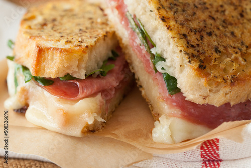 A gooey, Italian mozzarella and salami grilled cheese with a Parmesan toasted Italian bread