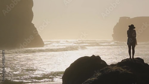 Twelve apostles beach on a sunny day at sunset surrounded by waves and cliffs in the nature - Great ocean road, Victoria, Australia. photo