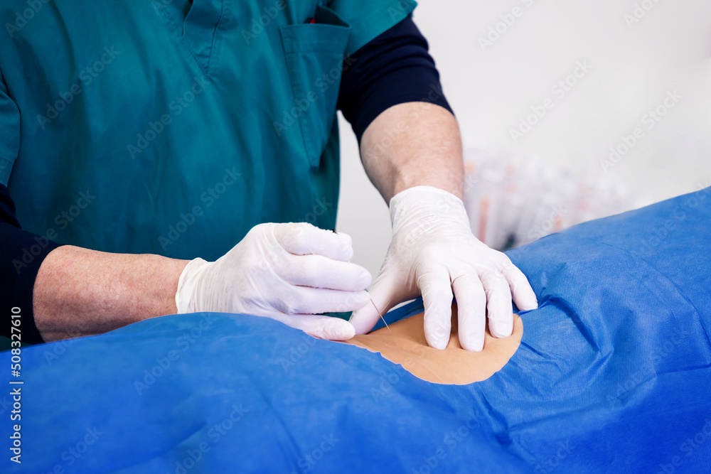 Infiltration for lumbar hernia. Ultrasound-guided infiltrative therapy for back pain treatment. Doctor practices the infiltration of drugs to the patient in the area affected. Infiltration for lumbar hernia. Ultrasound-guided infiltrative therapy for back pain treatment. Doctor practices the infiltration of drugs to the patient in the area affected.