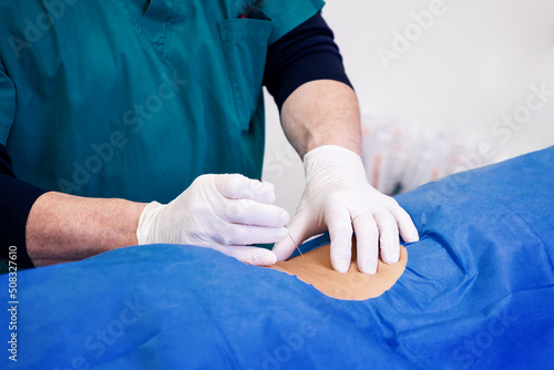 Infiltration for lumbar hernia. Ultrasound-guided infiltrative therapy for back pain treatment. Doctor practices the infiltration of drugs to the patient in the area affected.