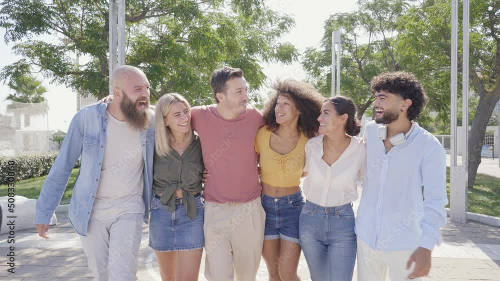 Happy group of smiling friends enjoying the summer holidays together and having fun together outdoors