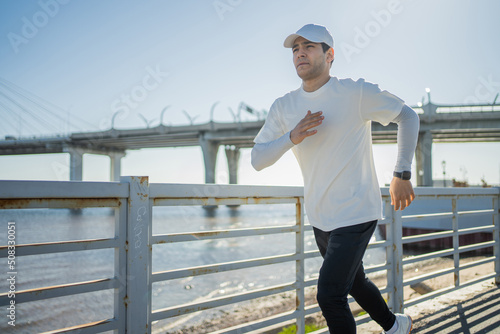 Male athlete Running outside active training, smart sports watch on hand