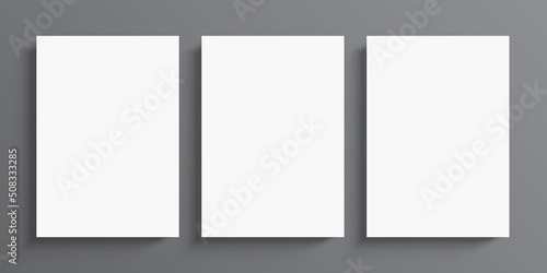 3 blank white paper posters hanging on grey wall background. Poster gallery vector mockup for art, image, or text placement.