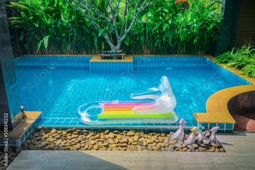 The rubber float is in the pool.Blue swimming pool.Outdoor Swimming Pool.