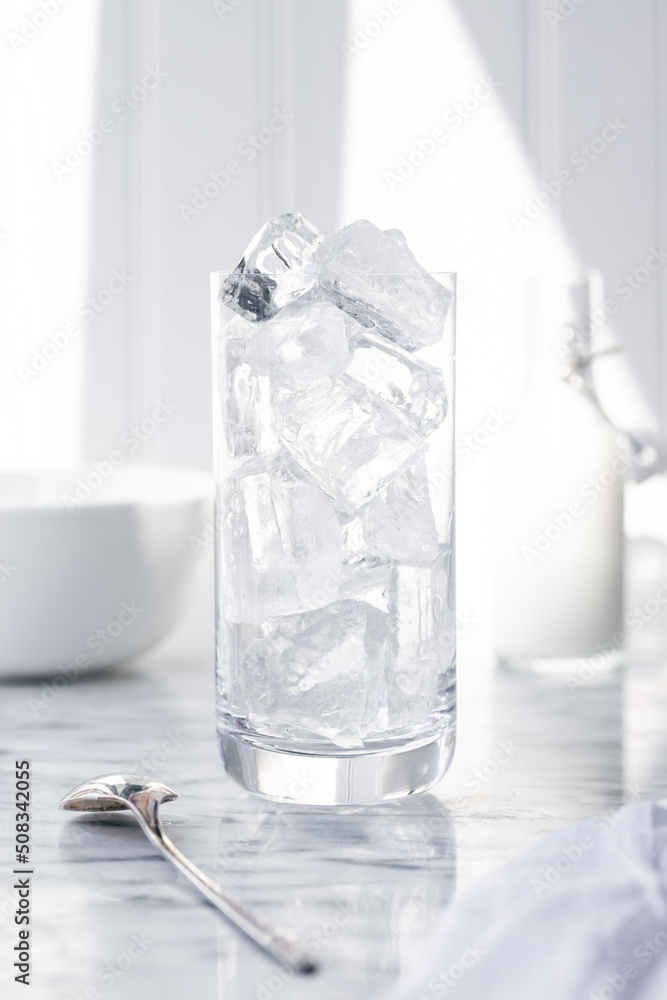 Glass being filled with clear ice by woman Glass being filled with clear ice by woman