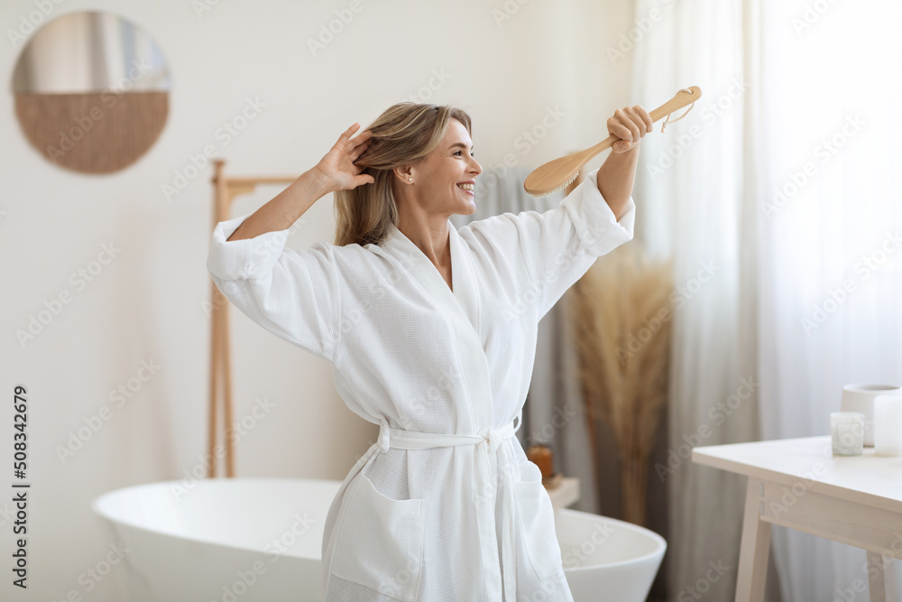 Joyful blonde woman having fun in bathroom, singing songs Joyful blonde woman having fun in bathroom, singing songs