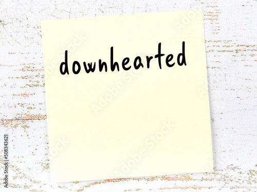 Yellow sticky note on wooden wall with handwritten word undecomposed photo