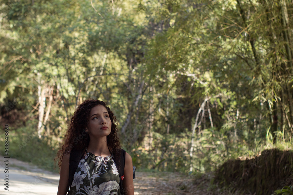 girl on a walk through the forest while enjoying nature and drinking water girl on a walk through the forest while enjoying nature and drinking water