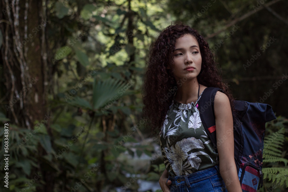 girl on a walk through the forest while enjoying nature and drinking water girl on a walk through the forest while enjoying nature and drinking water