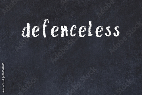 Tableau sur toile Black chalkboard with inscription defenceless on in