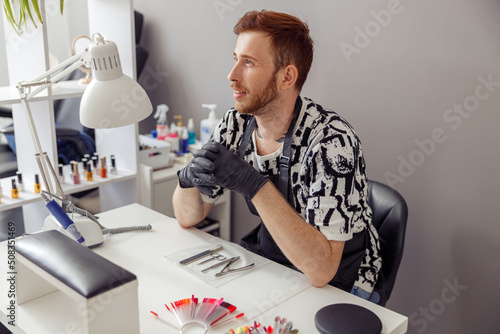 Experienced nail technician working in modern manicure salon