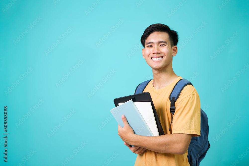 Confident student young man holding books. Confident student young man holding books.