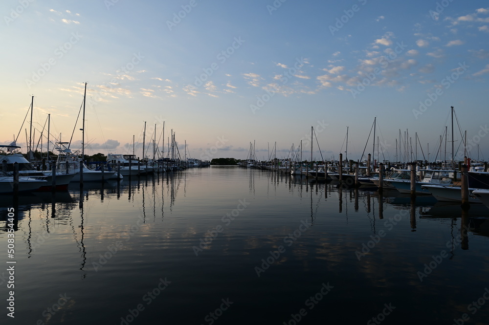Suummer cloudscape reflected in tranquil water of Dinner Key Marina in Coconut Grove, Miami, Florida.