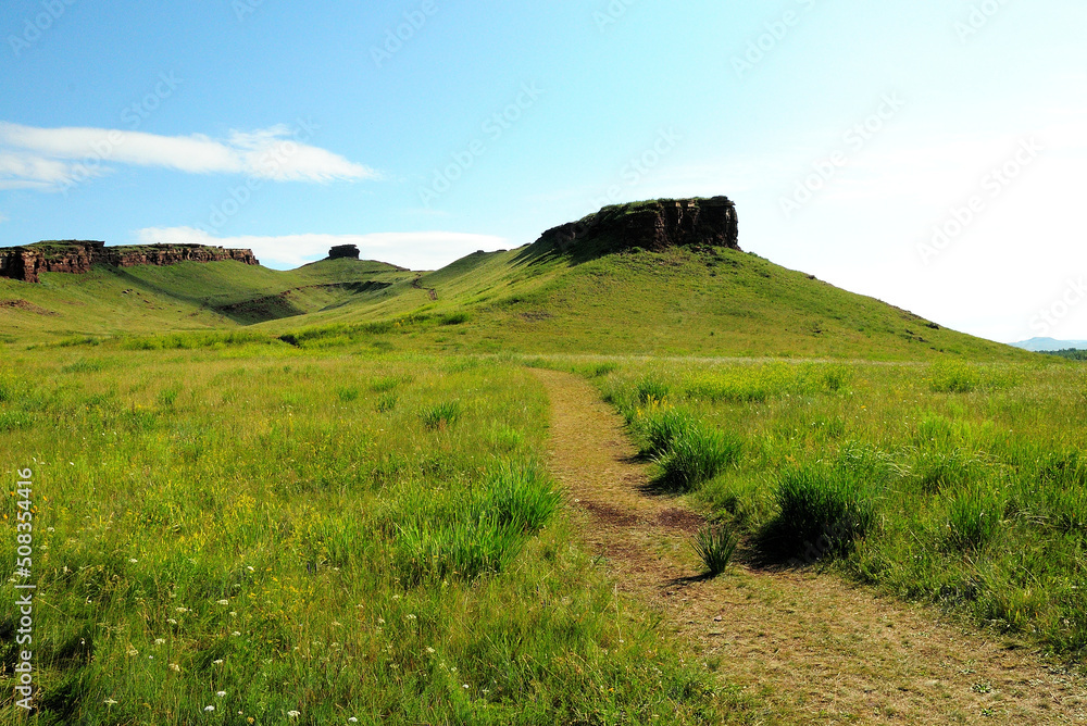 The path along the slope of the hill to its top, to the stone formations of an unusual shape. The path along the slope of the hill to its top, to the stone formations of an unusual shape.