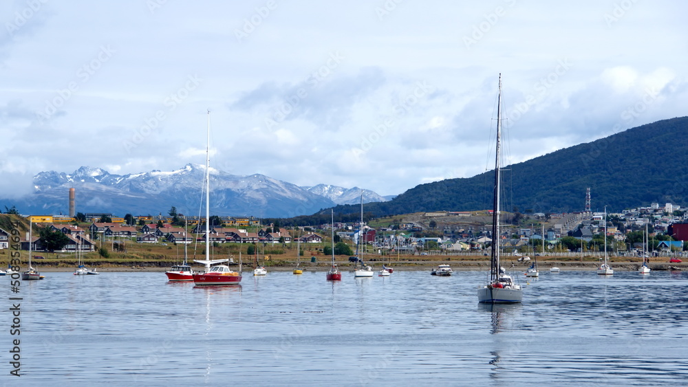 Sailboats in the harbor in Ushuaia, Argentina, with the Martial Mountains in the background
