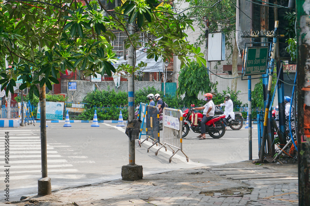 Kolkata, West Bengal, India - 22nd May 2020 : Few people are allowed to pass through busy city roads having barriers, under lockdown to stop spread of covid 19, corona virus in the state. Kolkata, West Bengal, India - 22nd May 2020 : Few people are allowed to pass through busy city roads having barriers, under lockdown to stop spread of covid 19, corona virus in the state.