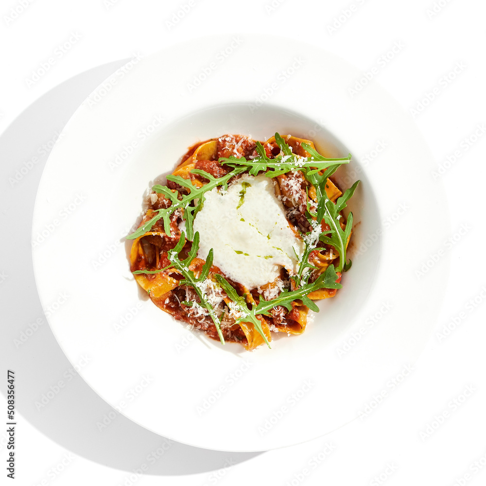 Italian pasta pappardelle with bolognese sauce  and parmesan isolated on white background. Pasta tagliatelle with meat ragu and creamy espuma with arugula. Minced beef in tomato sauce with pasta.