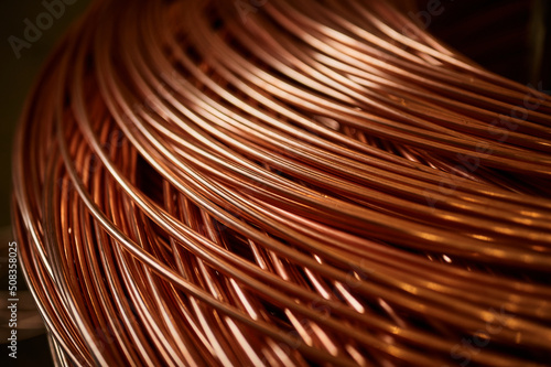 Foto Large bobbin of orange copper wire in light warehouse
