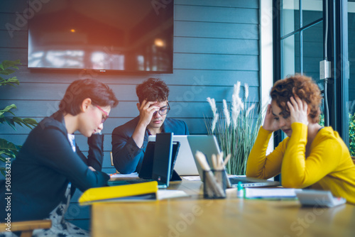 Young Asian office workers are thinking and in the stressful state of work to build their company's business success, teamwork concept with copy space.