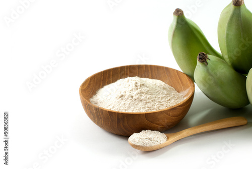 Banana flour and raw green bananas on a white background, prebiotic food for gut health.