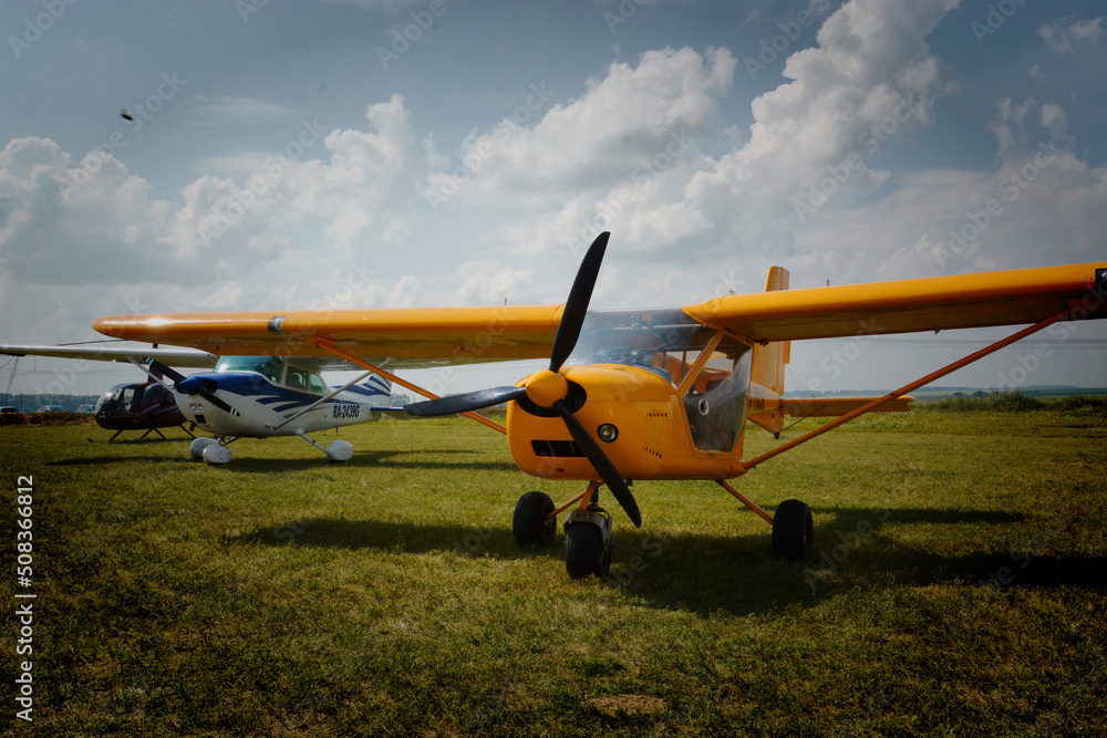 Children launch model airplanes at an air show on a summer day Children launch model airplanes at an air show on a summer day