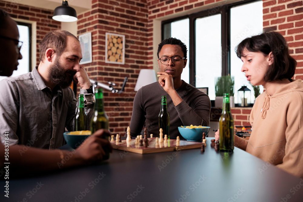 Pensive african american man thinking about next chess move while sitting  at table. Stock Photo by DC_Studio