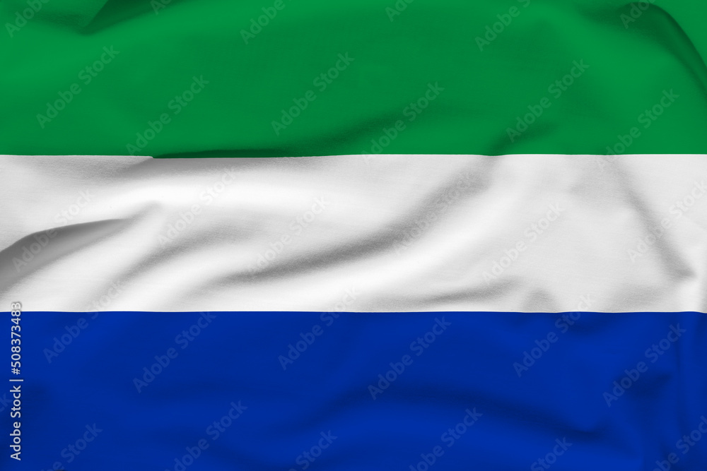 Sierra Leone national flag, folds and hard shadows on the canvas