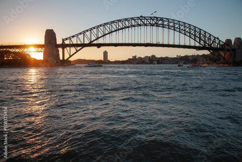 Large bridge across the bay at sunset on the water, Harbour Bridge, Sydney, Australia