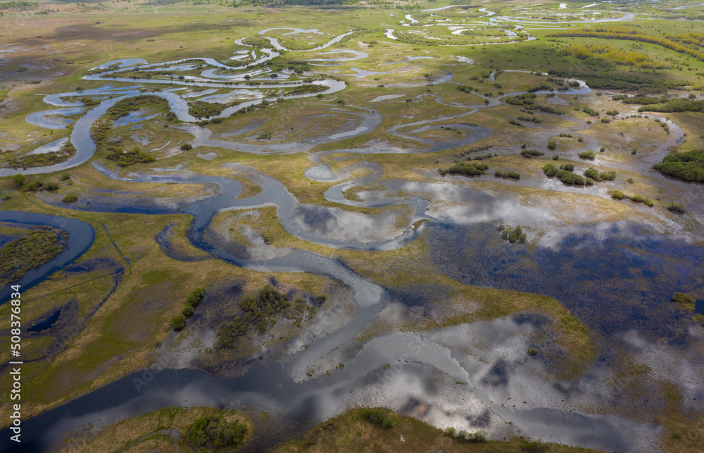 Aerial view of winding flooded river beds with ducts, during the spring flood.