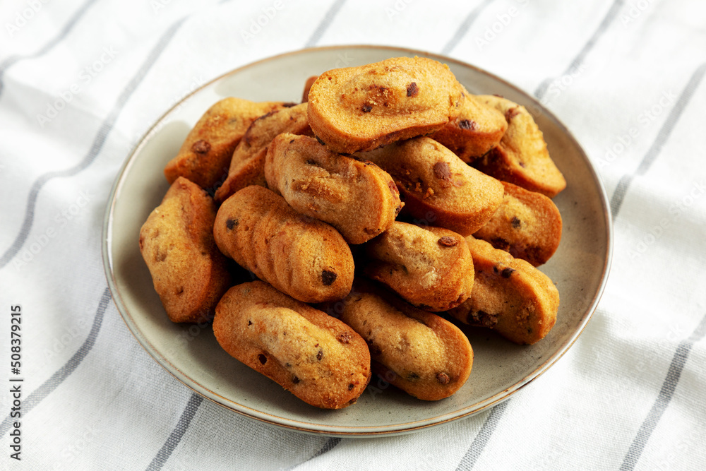 Homemade Chocolate Chips Madeleines on a Plate, side view. Homemade Chocolate Chips Madeleines on a Plate, side view.
