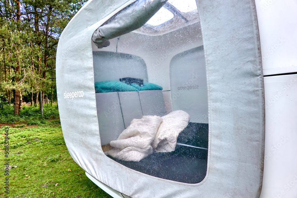 Sleepero sleeping, inside view of the pod on a lawn for overnight stays